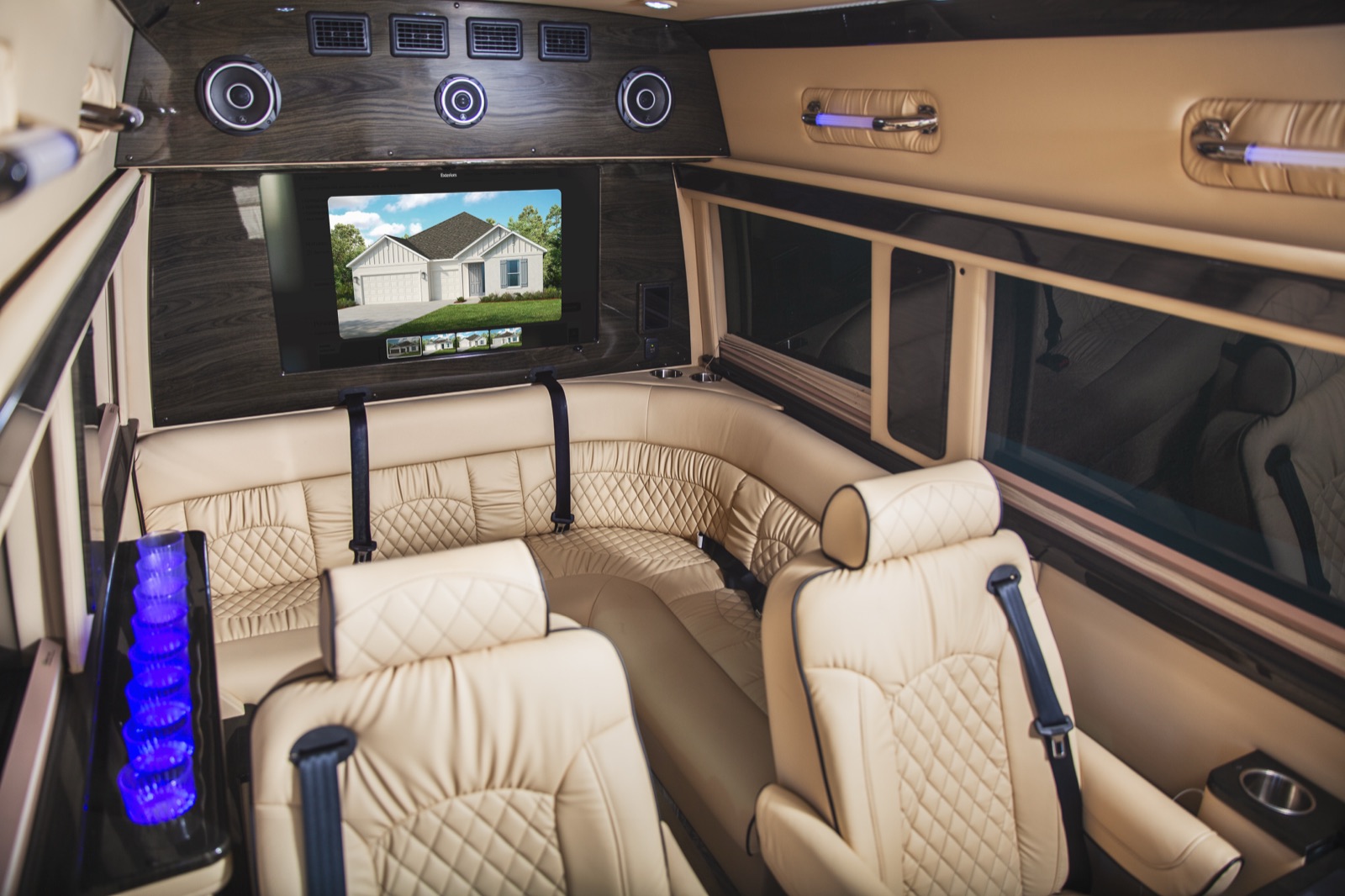 Van interior with a home listing on the large screen